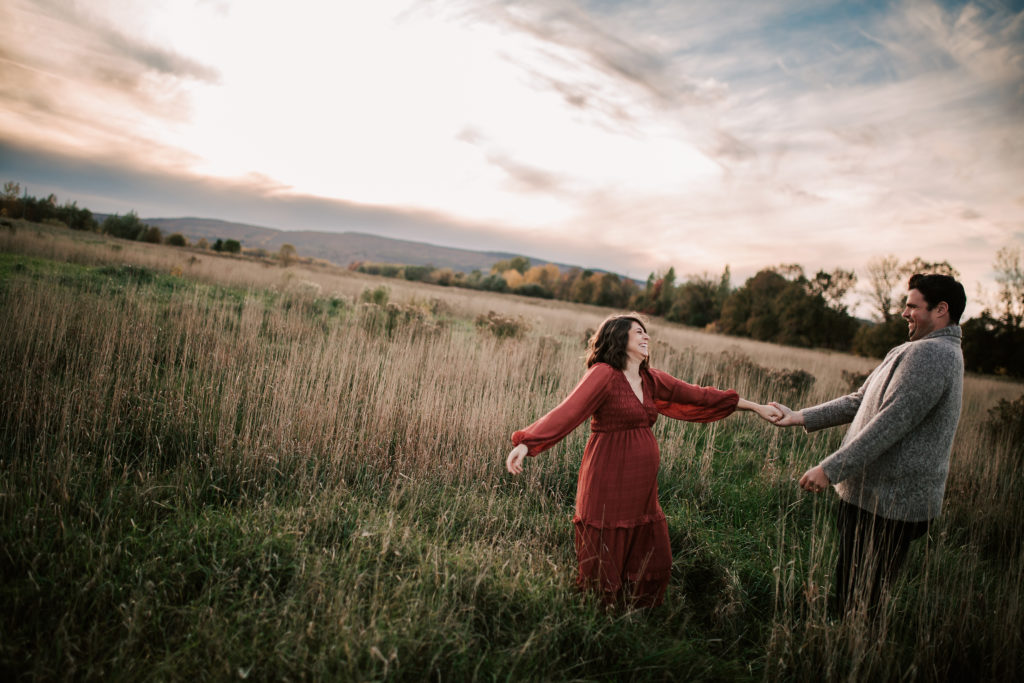 Kristen and Greg dancing in a grassy field.