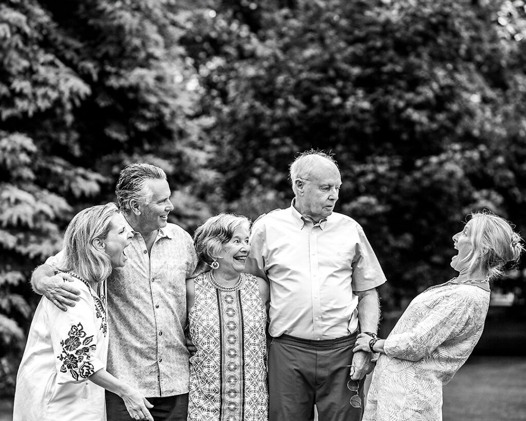 Extended family laughing together during outdoor family photo session near Collingwood Ontario