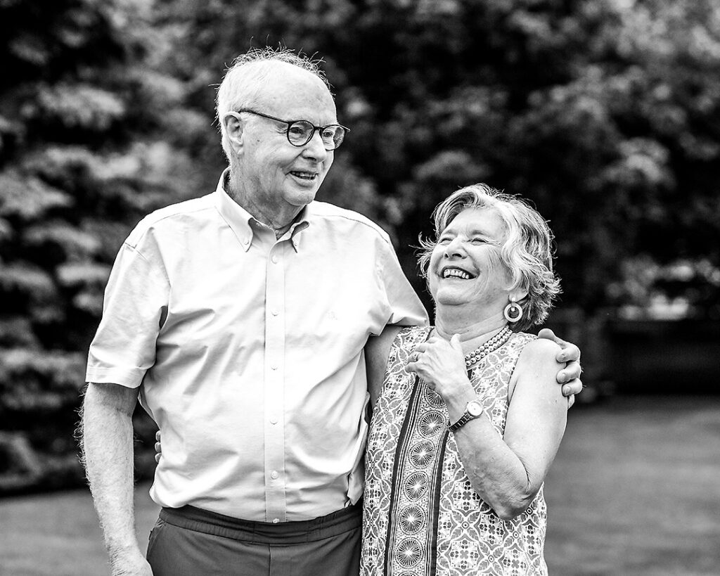 Grandparents from extended family laughing together during outdoor family photo session near Collingwood Ontario