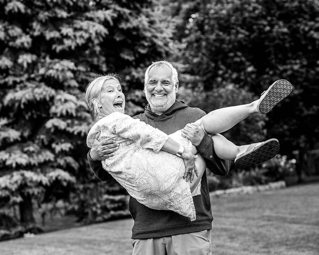 Couple from extended family laughing and acting silly together during outdoor family photo session near Collingwood Ontario