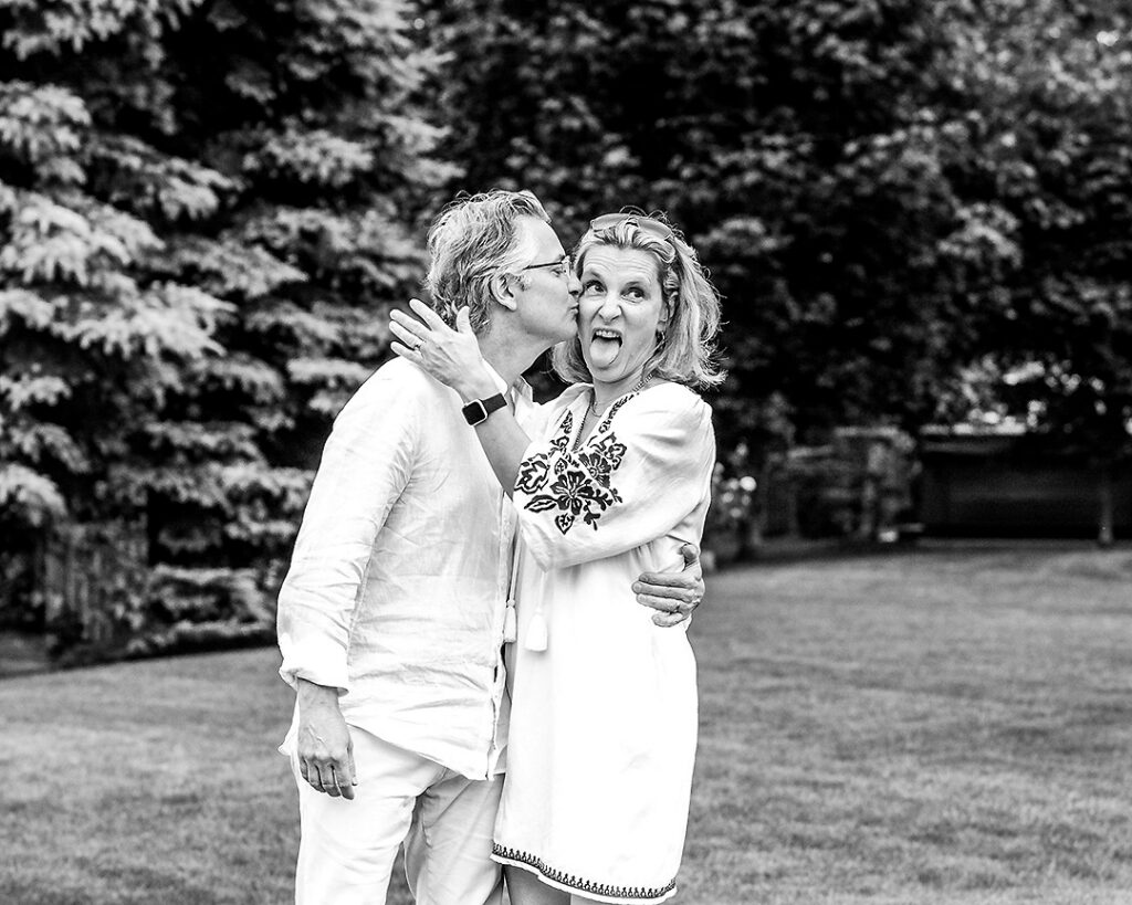 Couple from extended family laughing and acting silly together during outdoor family photo session near Collingwood Ontario