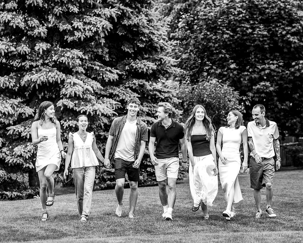 Teenage cousins laughing and walking together during outdoor family photo session near Collingwood Ontario