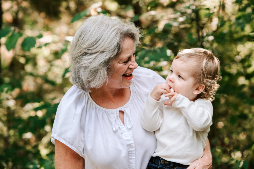 Grandmother embracing young grandchild during multigenerational family photography session in Collingwood