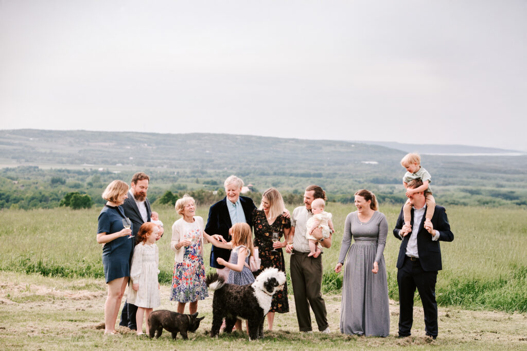 Extended family laughing together during outdoor family photo session near Collingwood Ontario