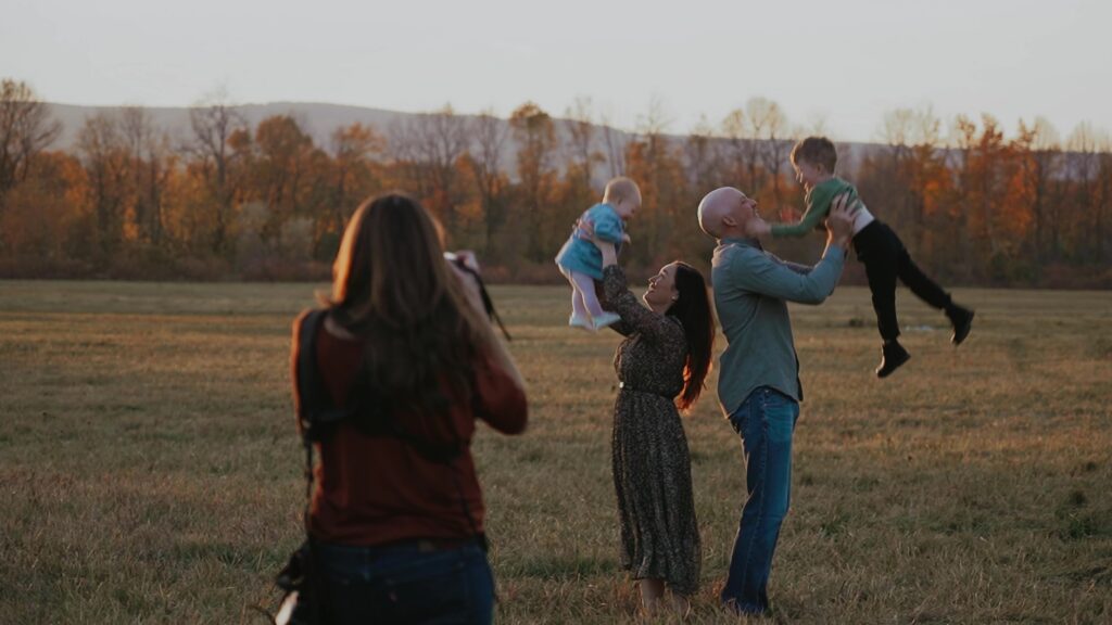 Family photographer Katie Lintern capturing genuine laughter during a full golden hour family session in Collingwood, Ontario.